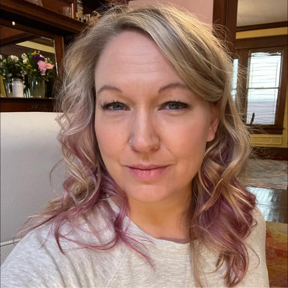A casual headshot of a white woman with blond hair.